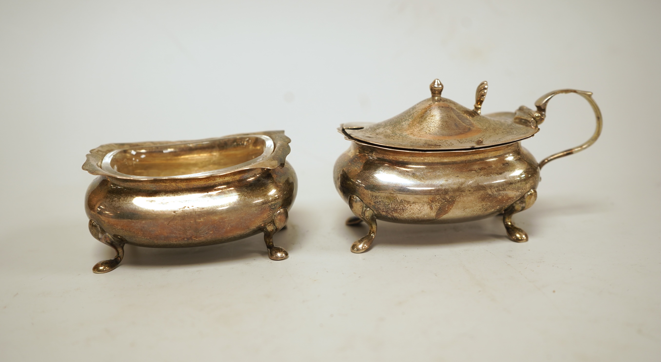 A pair of small George V silver five bar toast racks, Adie Brothers, Birmingham, 1930, length 76mm, together with six assorted silver condiments.